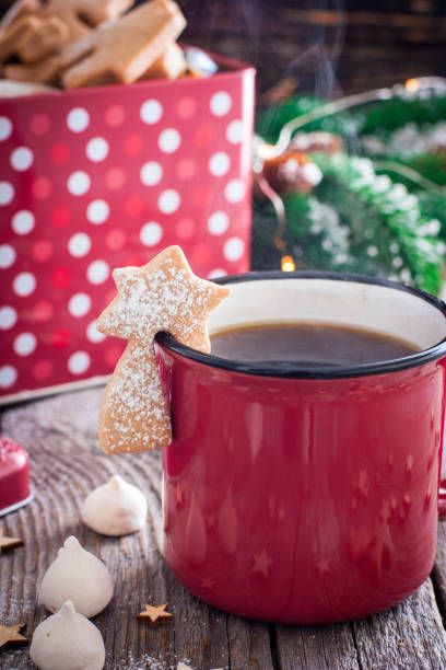 istock Red tea mug with cookies in Christmas decorations on a wooden table, selective focus 1072084232
