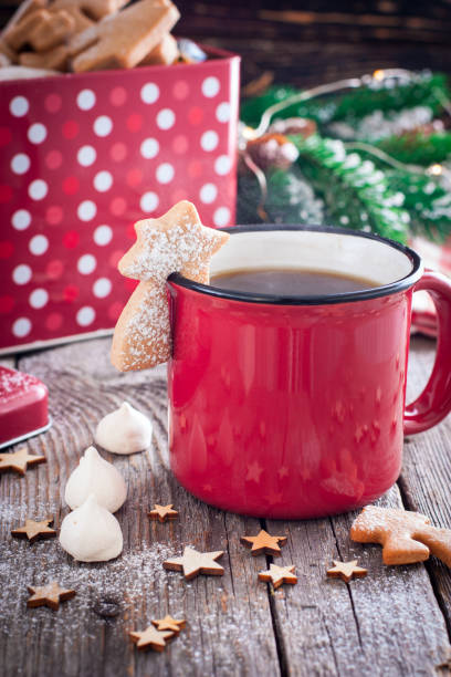 istock Red tea mug with cookies in Christmas decorations on a wooden table, selective focus 1072084244