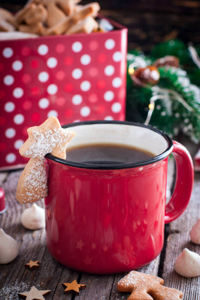 istock Red tea mug with cookies in Christmas decorations on a wooden table, selective focus 1072084442
