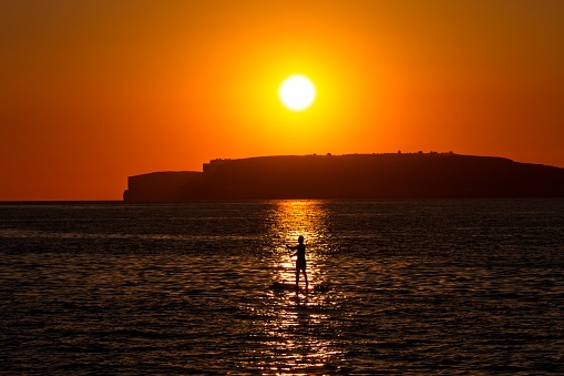 Paddle Board at Sunset in Malta looking towards Comino