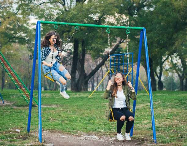 istock Two young women playing with swing in a park and have fun 1072089440