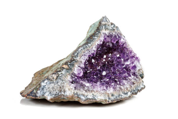 istock Macro Mineral Stone Amethysts in the rock on a white background 1072090490