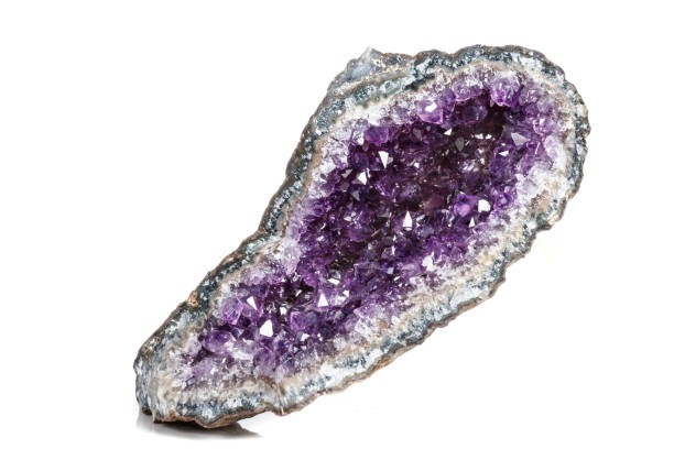 istock Macro Mineral Stone Amethysts in the rock on a white background 1072090816