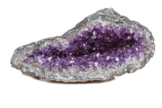 Macro Mineral Stone Amethysts in the rock on a white background