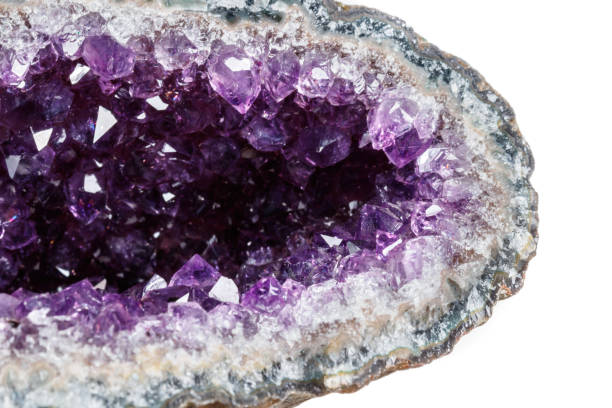 istock Macro Mineral Stone Amethysts in the rock on a white background 1072092038