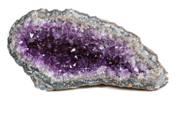 istock Macro Mineral Stone Amethysts in the rock on a white background 1072092064