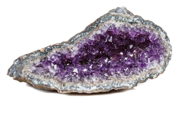 istock Macro Mineral Stone Amethysts in the rock on a white background 1072092258