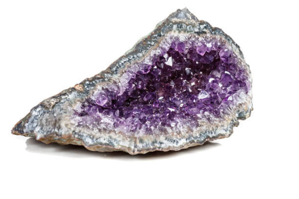 istock Macro Mineral Stone Amethysts in the rock on a white background 1072092266