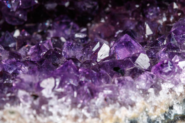 istock Macro Mineral Stone Amethysts in the rock on a white background 1072092284