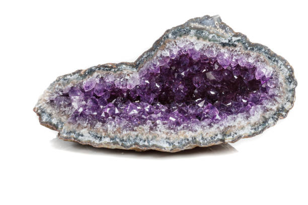istock Macro Mineral Stone Amethysts in the rock on a white background 1072092632