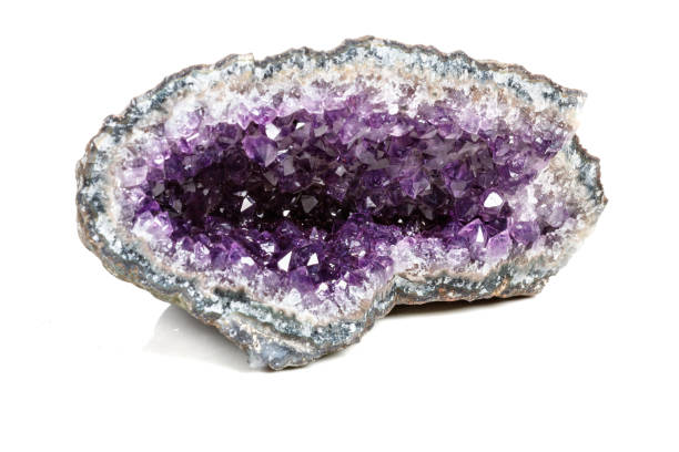 istock Macro Mineral Stone Amethysts in the rock on a white background 1072092768