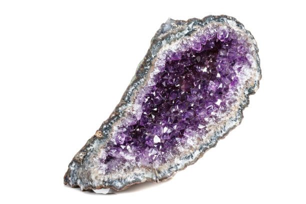 istock Macro Mineral Stone Amethysts in the rock on a white background 1072093052
