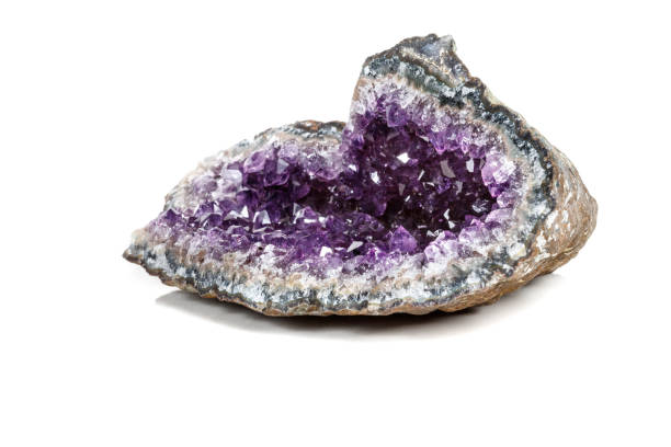 istock Macro Mineral Stone Amethysts in the rock on a white background 1072093078