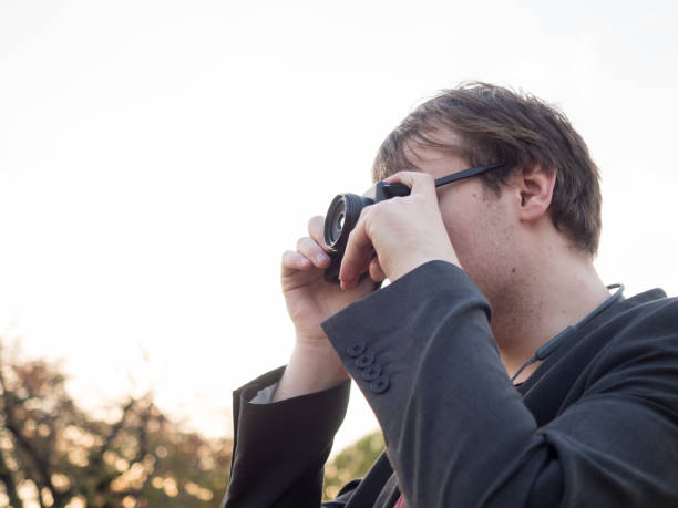 istock A man taking a picture on his digital camera. 1072096212