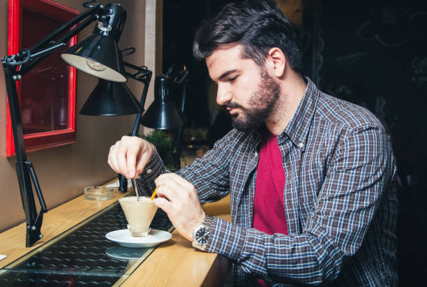 Young man relaxing with favorite coffee in cafe.