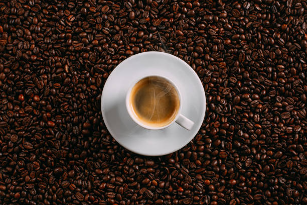 istock Steamy Coffee on Coffee Beans Background 1072108394