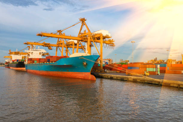 istock Container ship in export and import business and logistics. Shipping cargo to harbor by crane. Water transport International. Aerial view and top view. 1072112880