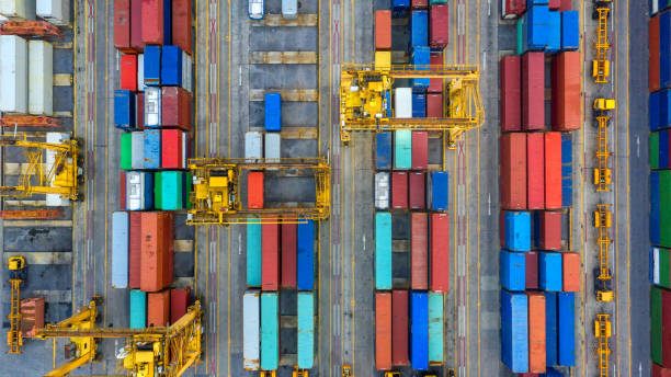 istock Container ship in export and import business and logistics. Shipping cargo to harbor by crane. Water transport International. Aerial view and top view. 1072112894