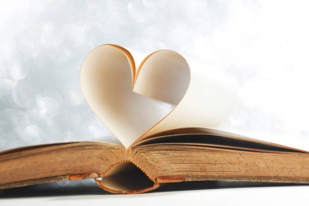 istock Pages of open book rolled in heart shape 1072112956