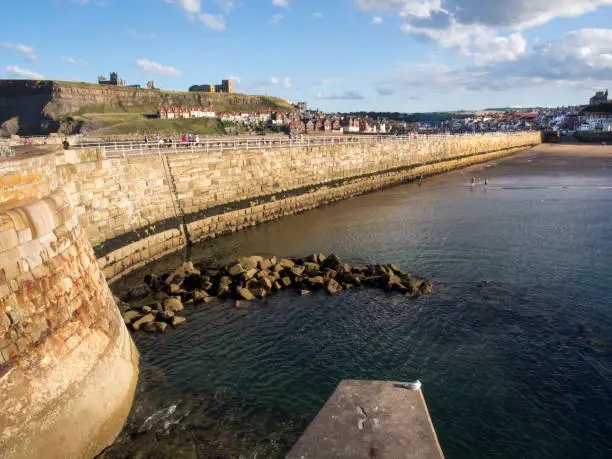 The pier, bay, and city of Whitby in Yorkshire, England.
