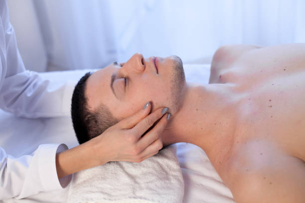 istock a massage therapist makes a man neck massage in the Spa 1072116158