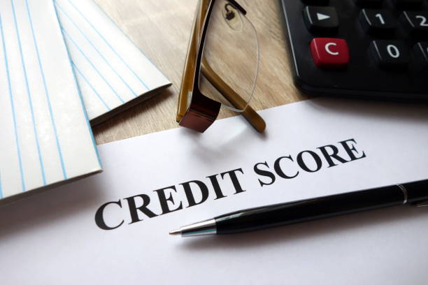 istock Credit score document with pen, calculator and glasses on desk 1072118252