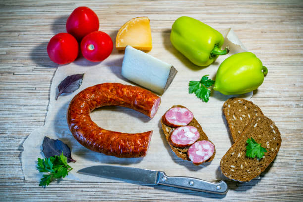 istock Products on the table – smoked sausage, brown bread, cheese and vegetables 1072118746
