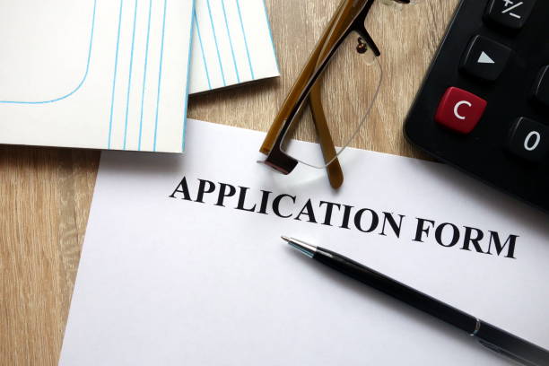 istock Application form with pen, calculator and glasses 1072118790