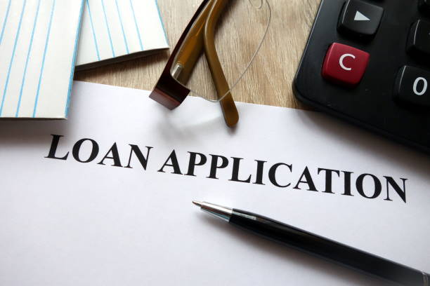 Loan application form Loan application form with pen, calculator and glasses on desk types of loans stock pictures, royalty-free photos & images