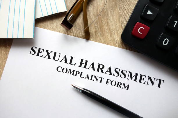 istock Sexual harassment complaint form with pen, calculator and glasses 1072120120
