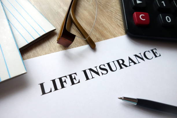 istock Life insurance document with pen, calculator and glasses on desk 1072120272