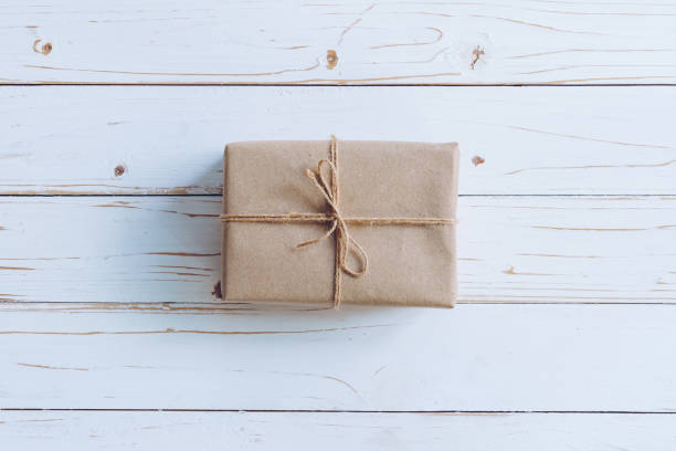 istock Above brown gift box on wooden table background with copy space. 1072120674
