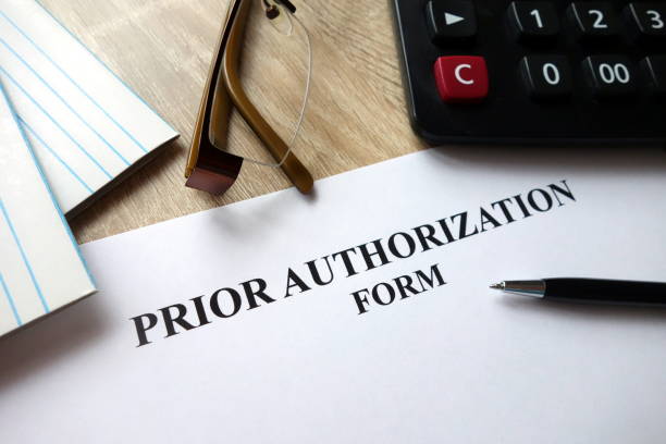 Prior authorization form Prior authorization form with pen, calculator and glasses on desk former photos stock pictures, royalty-free photos & images