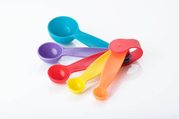 istock Kitchen Tools: Close up of Multi Colored Measuring Spoons Isolated on White Background 1072127156