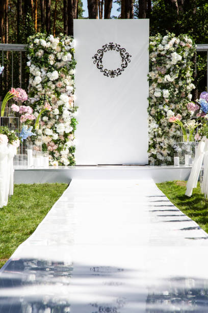 istock White wedding arch decorated with fresh flowers 1072128872