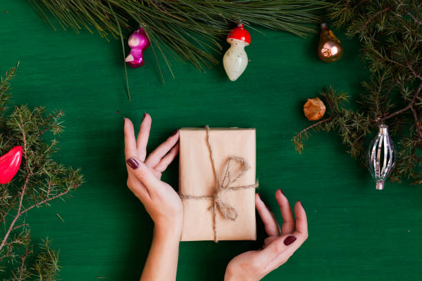 istock Christmas background hand new year coniferous branches presents winter postcard 1072128880