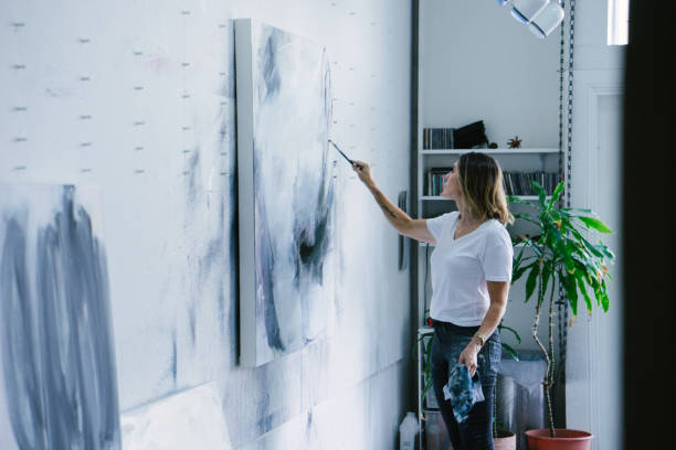 istock Woman painting canvas in art studio 1072132136