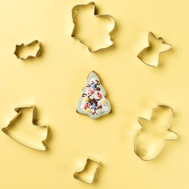 istock Christmas cookies various shape cutter on yellow background with copy space. Top view. Flat lay. Trendy colorful photo. Minimal style with colorful paper backdrop. Christmas concept 1072132760