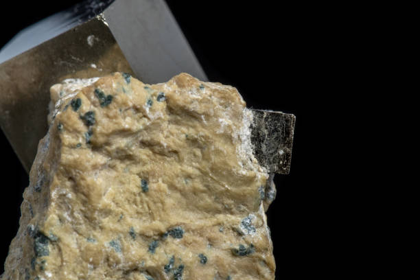 istock Macro Pyrite mineral stone on black background 1072134886