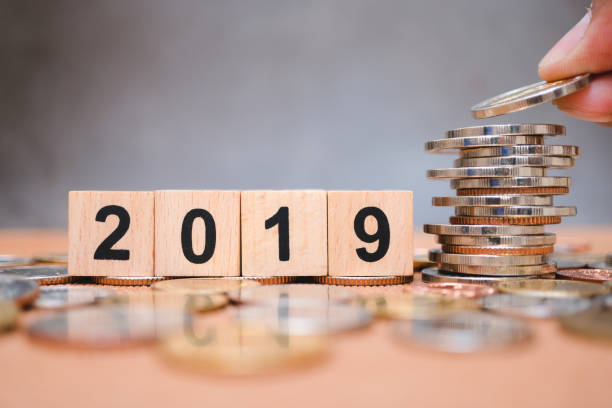 istock Wooden block year 2019 with hand holding 1072135358