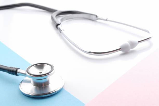 istock Stethoscope on white. Stethoscope on blue and pink background. Traditional stethoscope. 1072137874