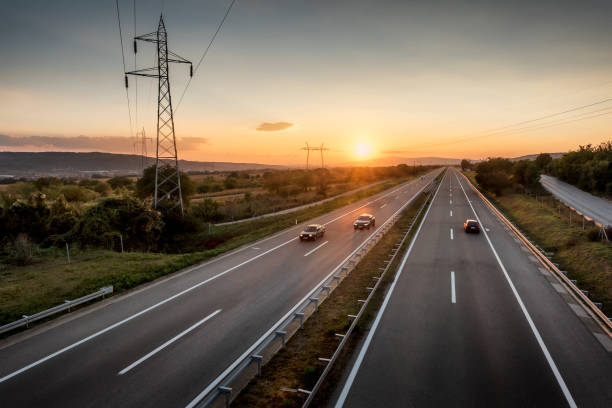 istock Light Highway Traffic on a straight road at sunset 1072138986
