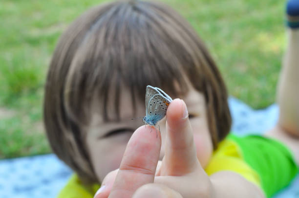 Little child with a butterfly on finger