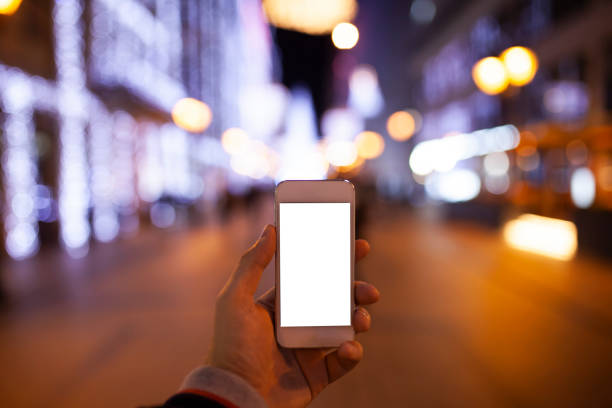 istock Hand holding empty screen of smart phone with bokeh 1072146772