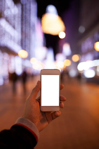 istock Hand holding empty screen of smart phone with bokeh 1072147784