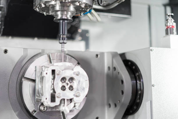 istock High precision CNC machining center 5 axis working, operator machining automotive sample part process 1072152146