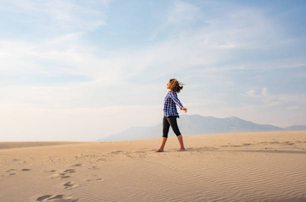 istock Girl walks on sand desert 1072156214