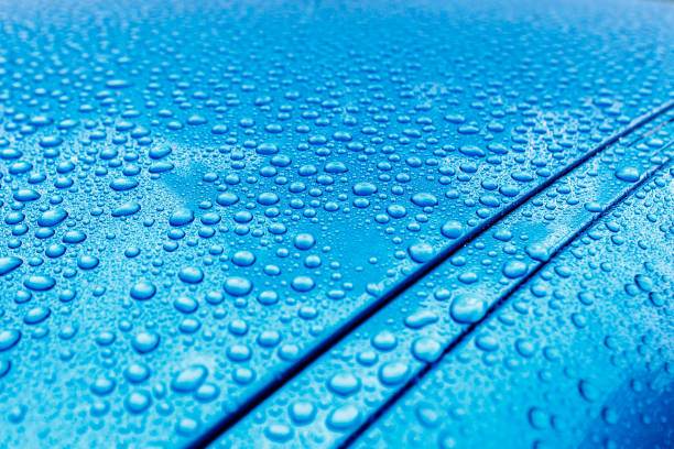 istock Raindrops close-up on a turquoise car body with Hydrophobic Effect. 1072164556