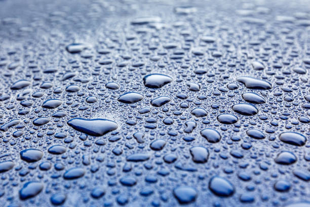 istock Raindrops close-up on a blue car body with Hydrophobic Effect. 1072164562