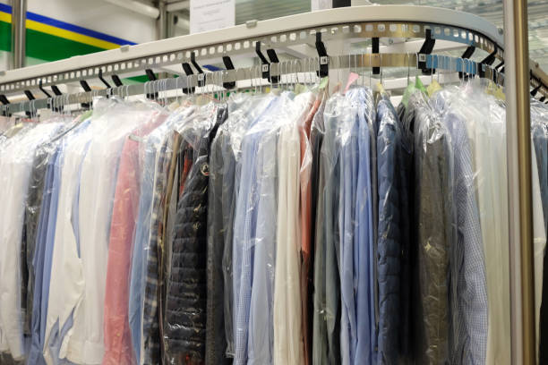 Dry-cleaning Dry cleaning: Clothes hang on the stand dry cleaner stock pictures, royalty-free photos & images